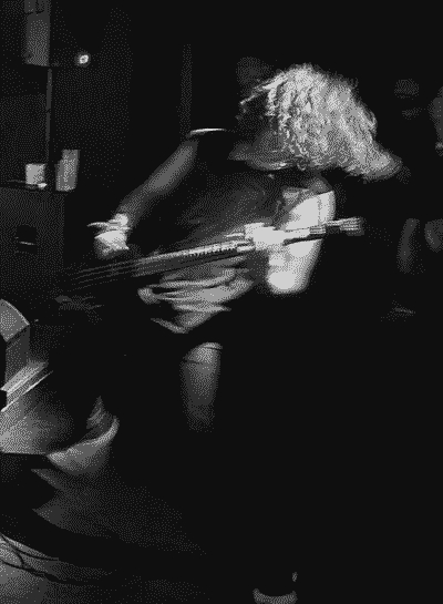 Picture of a human playing a bass guitar